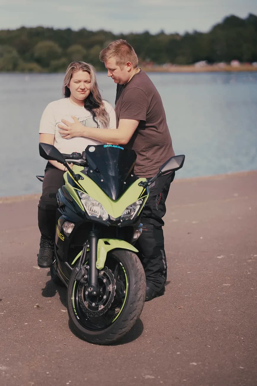 Patrycja and Krzysztof smiling together beside their motorbike